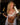 Bonnie Blue with her tongue out holding Fleshlight in one hand and champagne in the other wearing white lingerie with her 