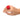 Hand wearing a red rose-shaped ring vibrator on a white background