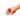 Hand wearing a red rose-shaped ring finger vibrator on a white background