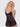 Woman wearing a Black lace nightgown against a white background