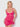 Woman wearing a pink lace nightgown against a white background