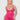 Woman wearing a pink lace nightgown against a white background