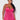 Woman wearing a pink lace nightgown against a white background