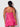 Woman wearing a pink lace nightgown against a white background