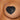 Black heart-shaped adhesive pastie with an arrow design on a person's chest.