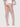 Person wearing sheer stockings and white lace lingerie on a plain background