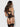 Woman wearing a black lace lingerie set on a white background