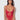Woman wearing a red lace lingerie set against a white background