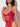 Woman wearing a red lace lingerie set against a white background