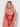 Woman wearing a red lace lingerie set against a white background