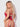 Woman wearing a red lace lingerie set against a white background