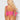 Person wearing a pink bikini with pom-pom details on a plain background