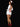 Person wearing a white nurse costume with red accents on a black background