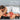 Man and woman in intimate positions using bondage cushion with text 'Put Them Where You Want Them' and 'Bedroom Bliss' branding.