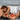 Bondage cushion with a man and woman in red lingerie lying on a bed.