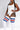 A model wearing a white bodysuit with thigh-high white socks featuring red and blue stripes, posed against a light gray studio background.