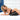 Woman in blue lingerie lying on a Black Liberator Wedge 24 Inch against a white tiled wall.
