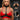 Model wearing a red leather bra and black vixen harness with iron D-rings, featuring cruelty-free vegan leather and high-quality materials.