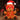 Teddy bear wearing a Santa hat, red mask, and harness with plaid accents on a wooden surface.