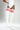 White thigh-high ribbed socks with three red stripes on the upper calves, modeled on a person wearing a white bodysuit against a light gray studio background.