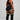 Person wearing black athletic outfit with colorful striped socks on a plain background