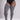 A model wearing gray ribbed thigh-high stockings with a black bodysuit, shown from the waist down against a light gray studio background.