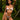 Woman in a light pink lingerie set standing in a lush green outdoor setting