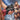 A close-up of a hand holding a black and red creature-style masturbator with a dragon-head shape and red eye, alongside a fantasy female warrior illustration and the text 'CREATURE COCKS' at the bottom.