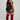 Person wearing black athletic top and shorts with red knee-high socks on a plain background
