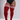 A model wearing red ribbed over-the-knee socks with three white stripes at the top, paired with a black bodysuit, shown against a light gray studio background.