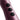 Close-up of a metallic pink-purple handheld device with three black circular buttons labeled minus, plus, and power.