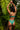 Woman in teal lingerie standing against a tropical leaf background