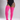 A model wearing bright pink ribbed over-the-knee socks or thigh-high stockings, paired with a black bodysuit, shown against a neutral gray studio background.