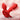 Red rose-shaped vibrator with a curved shaft and leaf-like flared base, shown on a soft pink gradient background with white motion arrows and heat lines indicating use. BLOOMGASM branding appears in the lower right.
