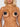 Naked person wearing black bow-shaped pasties on a plain background