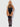 Woman wearing a black strappy bodysuit and thigh-high stockings on a white background