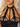 Black strappy top worn by a model with a neutral background