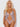Woman wearing a sheer lace lingerie set against a white background