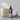 Bottle of 'Stroker' personal lubricant on a surface with tissues, a candle, and watch.