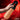 Hand holding a Jock masturbator against a red background