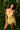 Woman wearing sheer yellow teddy in a forest setting