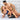 Man and woman in blue lingerie on a Liberator Wedge 24 Inch against a geometric-patterned wall.