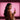 Woman holding a pink anal plug against a pink background