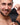 Man holding a Trinity Men 10X Pleasure Stroke Vibrating Silicone Penis Sleeve against a white background