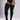 A model wearing black ribbed over-the-knee socks or thigh-high stockings, paired with a black bodysuit and sheer thigh-high stockings showing a tattooed leg.