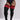 A model wearing black ribbed thigh-high socks with three red stripes near the top, paired with a black bodysuit against a light gray studio background.