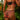 Woman wearing a black and red floral lingerie set against a blurred natural background