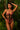Woman wearing a floral lingerie set against a tropical background