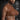Man with measurements labeled on his chest against a dark brick wall background