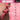 Pink flexible Piggy Tail Anal Plug held by a hand with 'Tailz' branding and feature list on a pink background.